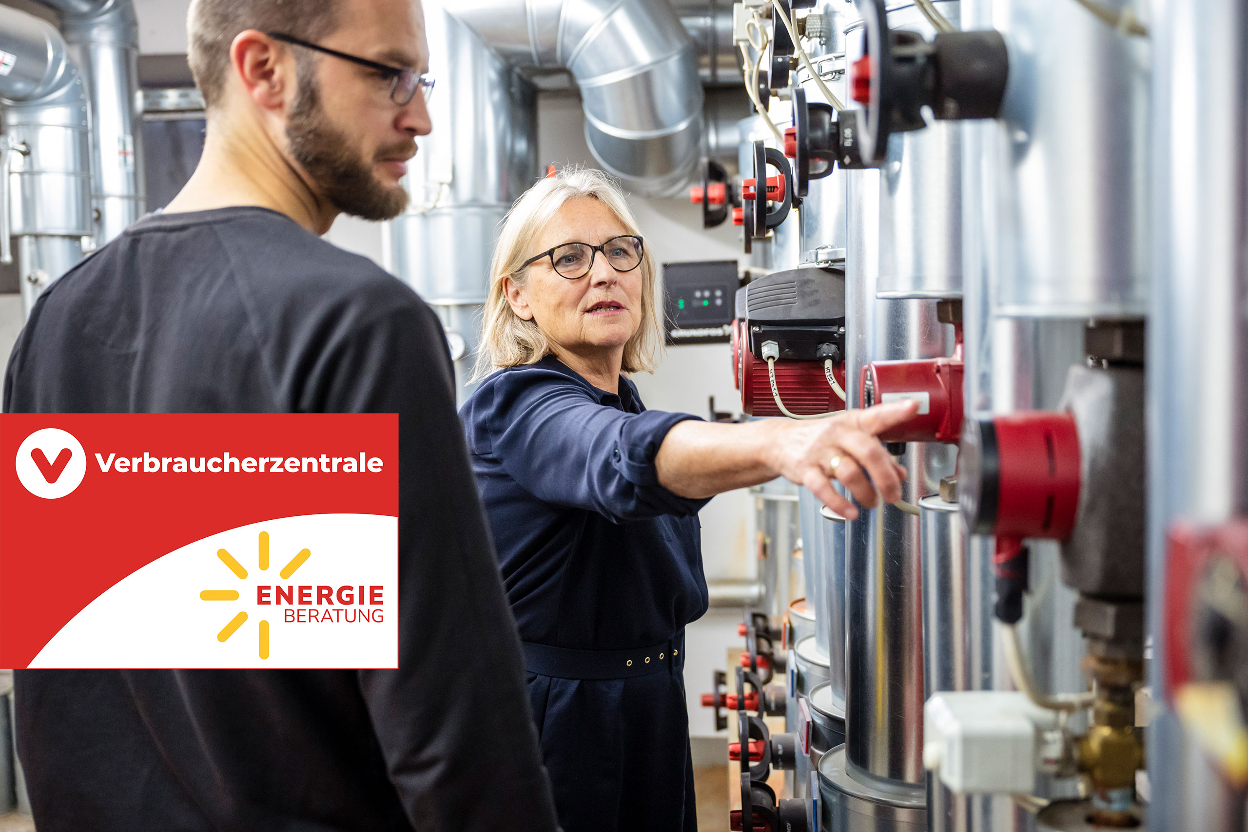 Mann und Frau bei einer Energieberatung im Heizungskeller